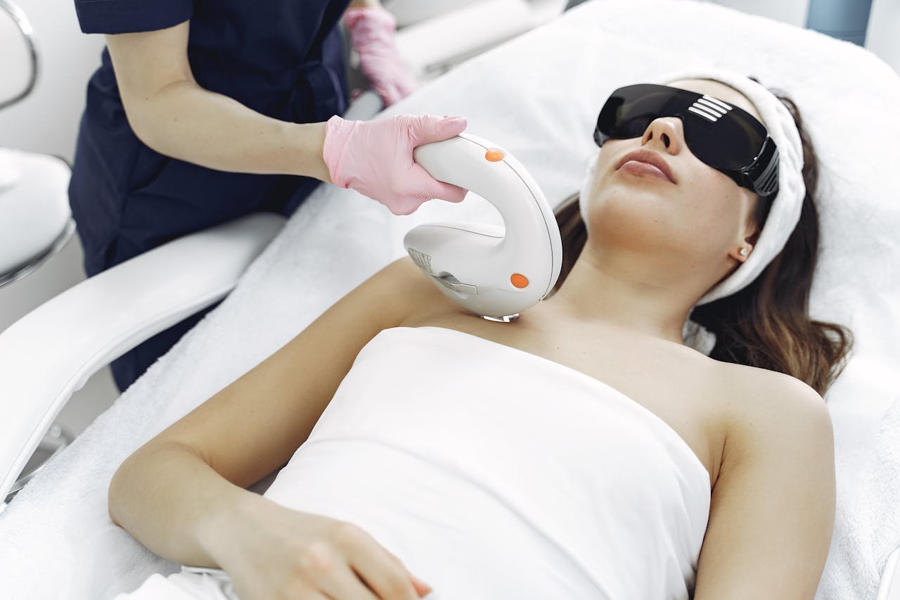 Young woman receiving a laser aesthetic medicine treatment